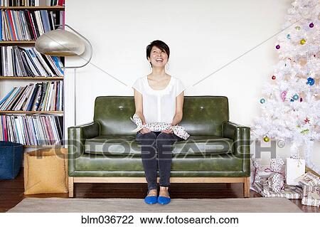 Japanese woman holding gift near Christmas tree View Large Photo Image Stock Image - Japanese woman holding gift near Christmas tree. Fotosearch