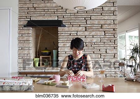 Stock Photography - Japanese woman wrapping gifts. Fotosearch
