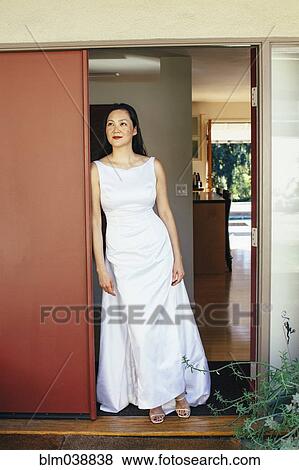 Korean bride wearing wedding dress in doorway View Large Photo Image Stock Photo - Korean bride wearing wedding dress in doorway. Fotosearch