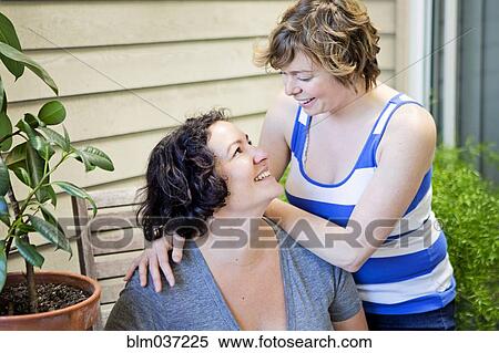 Lesbian couple relaxing in backyard View Large Photo Image Stock Photography - Lesbian couple relaxing in backyard. Fotosearch