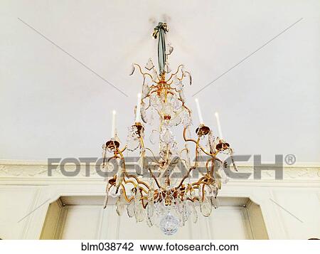 Low angle view of chandelier hanging from ceiling View Large Photo Image Stock Image - Low angle view of chandelier hanging from ceiling. Fotosearch