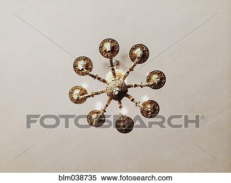 Stock Photography - Low angle view of chandelier hanging from ceiling. Fotosearch