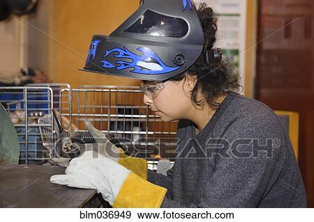 Stock Photo - Middle Eastern technician operating machinery in warehouse. Fotosearch