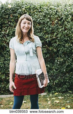 Mixed race businesswoman holding digital tablet in backyard View Large Photo Image Stock Image - Mixed race businesswoman holding digital tablet in backyard. Fotosearch