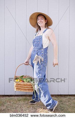 Mixed race farmer holding basket of vegetables View Large Photo Image Stock Image - Mixed race farmer holding basket of vegetables. Fotosearch