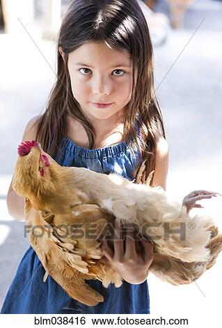 Mixed race girl holding chicken View Large Photo Image Stock Photograph - Mixed race girl holding chicken. Fotosearch