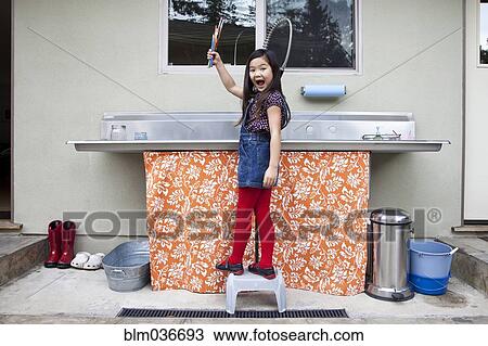Mixed race girl showing clean paintbrushes at sink View Large Photo Image Stock Image - Mixed race girl showing clean paintbrushes at sink. Fotosearch