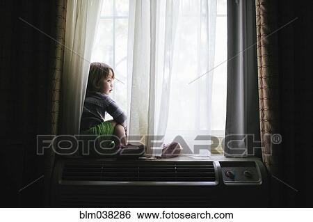 Mixed race girl sitting in window View Large Photo Image Stock Photograph - Mixed race girl sitting in window. Fotosearch