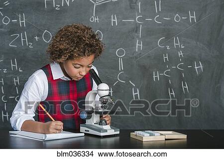 Mixed race student using microscope in science class View Large Photo Image Picture - Mixed race student using microscope in science class. Fotosearch