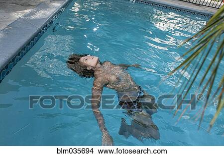 Mixed race woman swimming in pool View Large Photo Image Picture - Mixed race woman swimming in pool. Fotosearch