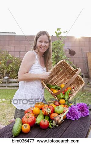 Mixed race woman with basket of vegetables and flowers View Large Photo Image Stock Photo - Mixed race woman with basket of vegetables and flowers. Fotosearch