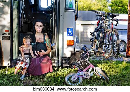 Mother and children sitting in bus doorway View Large Photo Image Picture - Mother and children sitting in bus doorway. Fotosearch