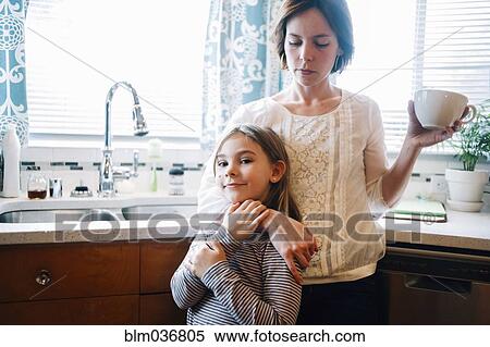 Mother and daughter hugging in kitchen View Large Photo Image Stock Photography - Mother and daughter hugging in kitchen. Fotosearch