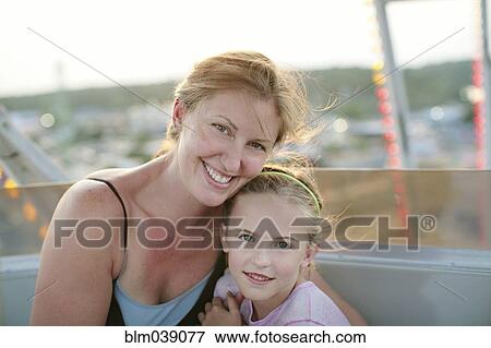 Stock Photo - Mother and daughter hugging outdoors. Fotosearch