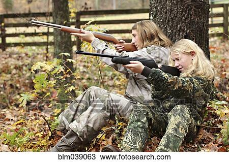 Mother and daughter in camouflage aiming rifles in forest View Large Photo Image Stock Image - Mother and daughter in camouflage aiming rifles in forest. Fotosearch