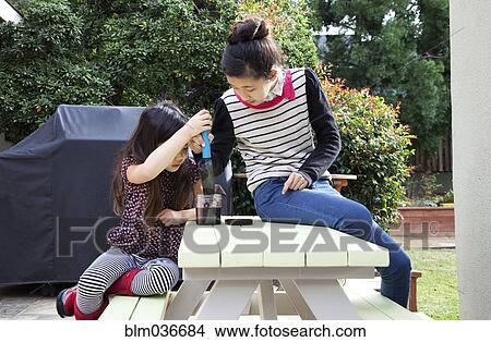 Mother and daughter playing in backyard View Large Photo Image Picture - Mother and daughter playing in backyard. Fotosearch