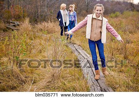 Mother and daughters walking in rural field View Large Photo Image Stock Image - Mother and daughters walking in rural field. Fotosearch