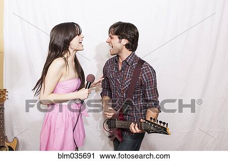 Musicians playing guitar and singing View Large Photo Image Stock Image - Musicians playing guitar and singing. Fotosearch