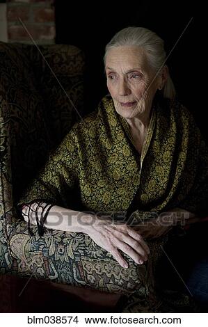 Picture - Older Caucasian woman sitting in armchair. Fotosearch