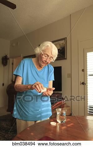 Older Caucasian woman taking medication View Large Photo Image Picture - Older Caucasian woman taking medication. Fotosearch