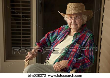 Stock Image - Older Caucasian woman wearing cowboy hat. Fotosearch