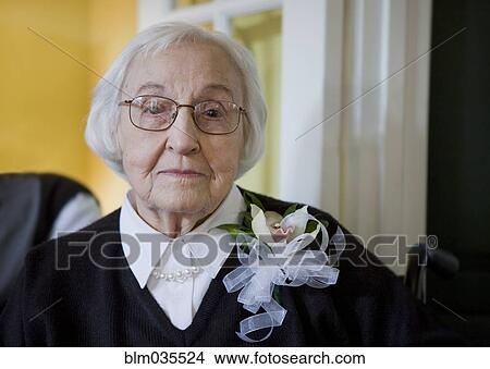 Older Caucasian woman wearing flower corsage View Large Photo Image Picture - Older Caucasian woman wearing flower corsage. Fotosearch