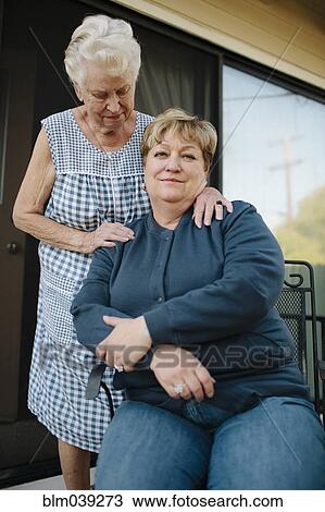 Older woman standing with daughter View Large Photo Image Stock Image - Older woman standing with daughter. Fotosearch