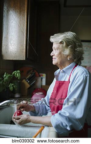 Older woman washing dishes in kitchen sink View Large Photo Image Stock Image - Older woman washing dishes in kitchen sink. Fotosearch