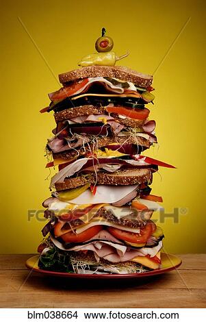 Oversized stacked deli sandwich on plate View Large Photo Image Picture - Oversized stacked deli sandwich on plate. Fotosearch