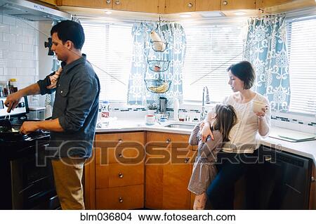 Parents and daughter cooking in kitchen View Large Photo Image Picture - Parents and daughter cooking in kitchen. Fotosearch