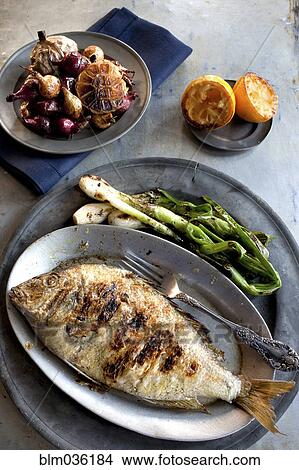 Plates of grilled fish, vegetables and garlic View Large Photo Image Picture - Plates of grilled fish, vegetables and garlic. Fotosearch
