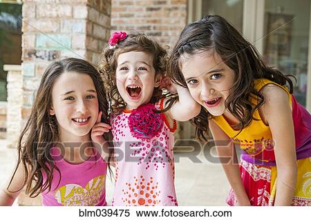 Playful sisters smiling outdoors View Large Photo Image Stock Photography - Playful sisters smiling outdoors. Fotosearch