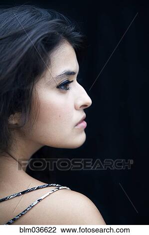 Stock Image - Profile of serious mixed race woman. Fotosearch