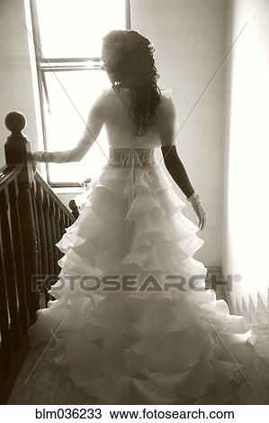 Rear view of bride walking down staircase View Large Photo Image Stock Image - Rear view of bride walking down staircase. Fotosearch