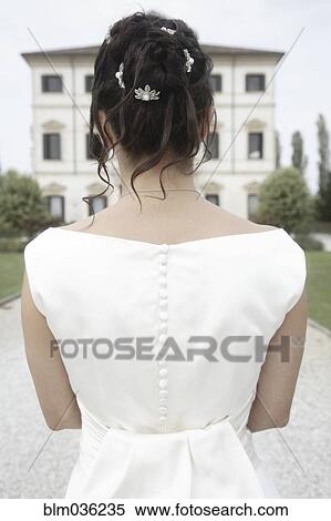 Stock Photography - Rear view of Caucasian bride in wedding gown. Fotosearch