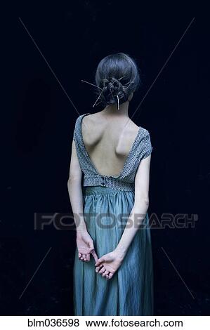Stock Photo - Rear view of woman wearing evening gown. Fotosearch