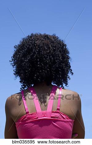 Rear view of woman with curly hair View Large Photo Image Stock Photography - Rear view of woman with curly hair. Fotosearch
