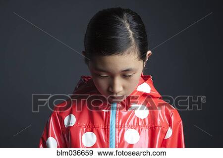 Sad Asian girl wearing raincoat View Large Photo Image Stock Photo - Sad Asian girl wearing raincoat. Fotosearch