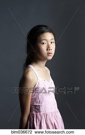 Serious Asian girl wearing dress View Large Photo Image Stock Image - Serious Asian girl wearing dress. Fotosearch