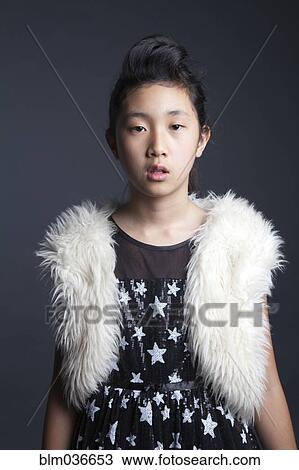 Serious Asian girl wearing furry vest View Large Photo Image Stock Image - Serious Asian girl wearing furry vest. Fotosearch