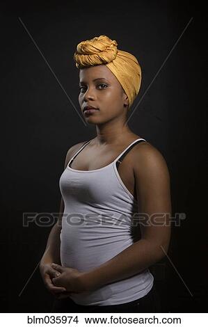 Serious Black woman wearing headwrap View Large Photo Image Picture - Serious Black woman wearing headwrap. Fotosearch