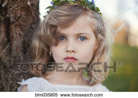 Serious Caucasian girl near tree View Large Photo Image Stock Photography - Serious Caucasian girl near tree. Fotosearch