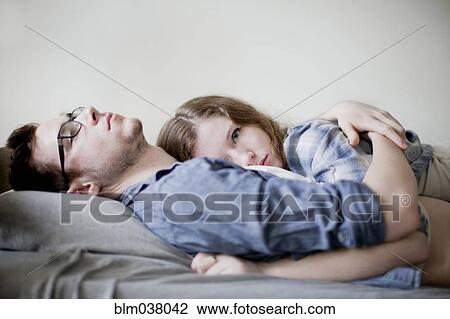 Serious couple hugging on bed View Large Photo Image Stock Image - Serious couple hugging on bed. Fotosearch