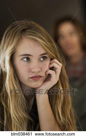 Serious teenage girl examining herself in mirror View Large Photo Image Stock Image - Serious teenage girl examining herself in mirror. Fotosearch