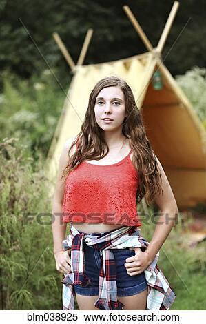 Serious woman standing at camping tent View Large Photo Image Stock Photography - Serious woman standing at camping tent. Fotosearch