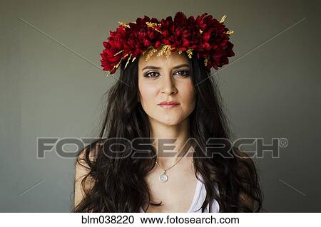 Stock Image - Serious woman wearing flower crown. Fotosearch
