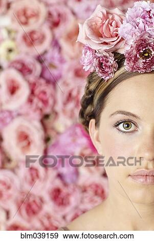 Stock Photo - Serious woman wearing flowers in her hair. Fotosearch