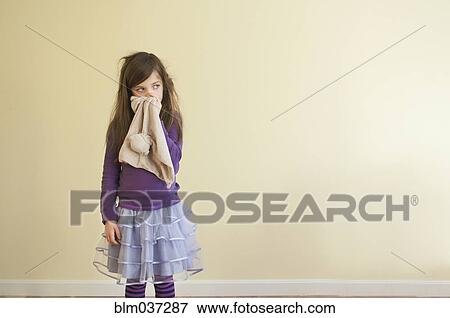 Sick Caucasian girl wiping nose View Large Photo Image Stock Photo - Sick Caucasian girl wiping nose. Fotosearch