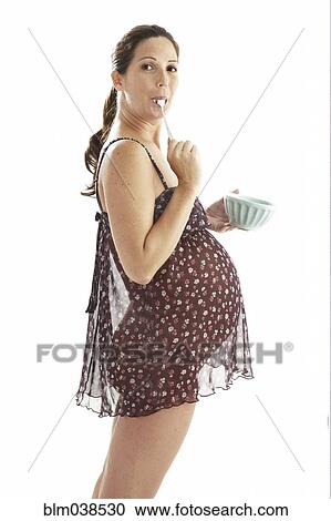 Side view of pregnant woman eating from bowl View Large Photo Image Stock Image - Side view of pregnant woman eating from bowl. Fotosearch