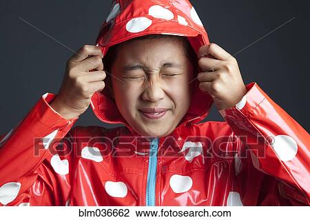 Smiling Asian girl wearing hooded raincoat View Large Photo Image Stock Image - Smiling Asian girl wearing hooded raincoat. Fotosearch